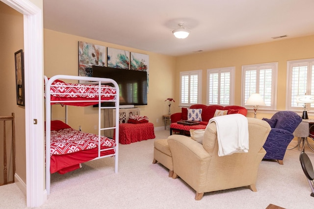 carpeted bedroom with visible vents and baseboards