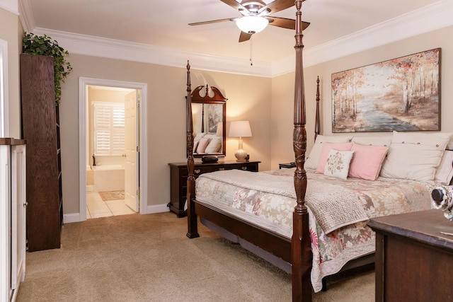 bedroom featuring crown molding, baseboards, carpet, and ensuite bath