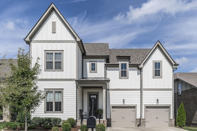modern inspired farmhouse with concrete driveway, an attached garage, board and batten siding, and a shingled roof