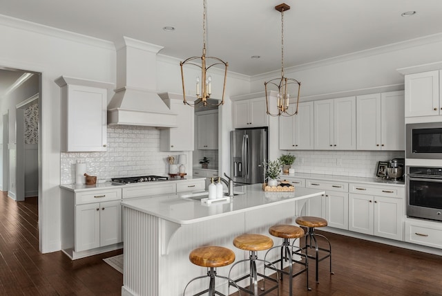 449 River Bluff Dr, Franklin, TN 37064 - kitchen featuring crown molding, light countertops, a sink, appliances with stainless steel finishes, and a notable chandelier