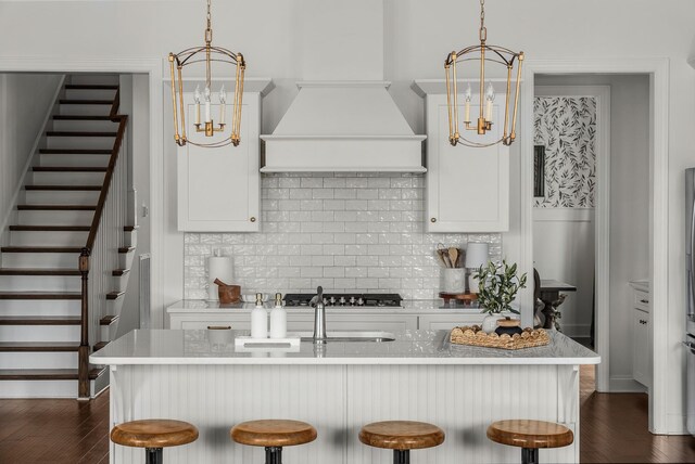 449 River Bluff Dr, Franklin, TN 37064 - kitchen with light countertops, a kitchen breakfast bar, an inviting chandelier, and tasteful backsplash
