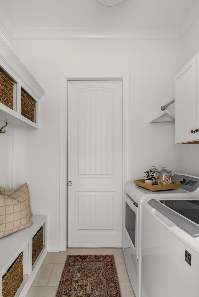 449 River Bluff Dr, Franklin, TN 37064 - laundry area featuring crown molding, light tile patterned floors, cabinet space, and washing machine and clothes dryer
