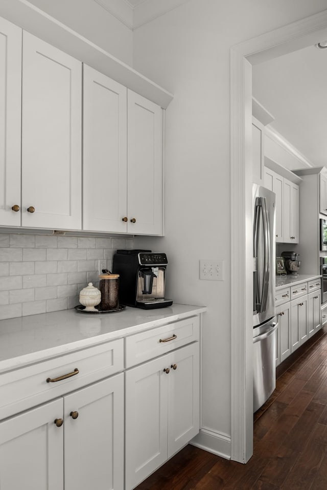 449 River Bluff Dr, Franklin, TN 37064 - kitchen featuring appliances with stainless steel finishes, decorative backsplash, dark wood-style flooring, and white cabinets