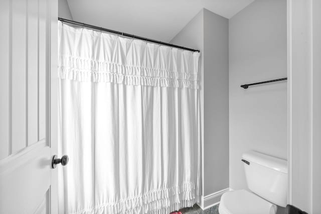 full bath with baseboards and toilet