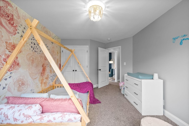 carpeted bedroom with baseboards and a closet