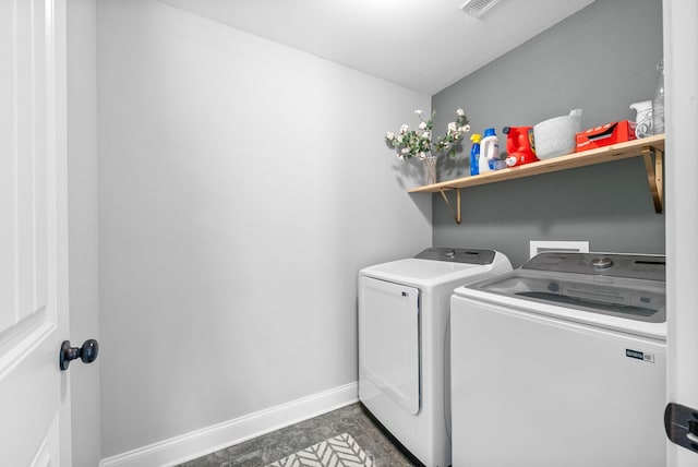 laundry room with baseboards, laundry area, visible vents, and washer and clothes dryer