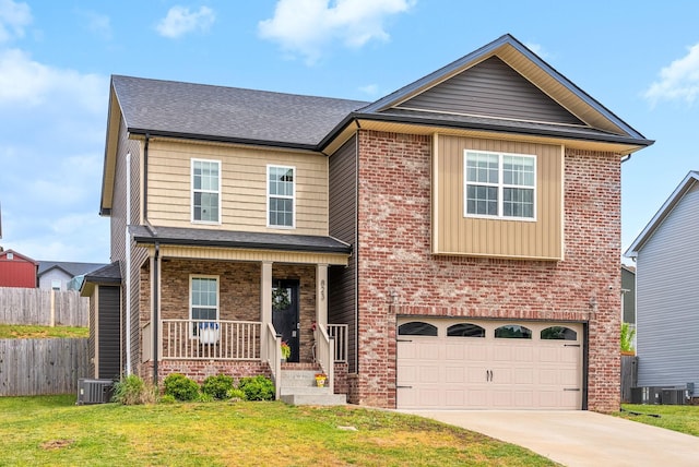craftsman-style home with fence, an attached garage, a front yard, covered porch, and driveway