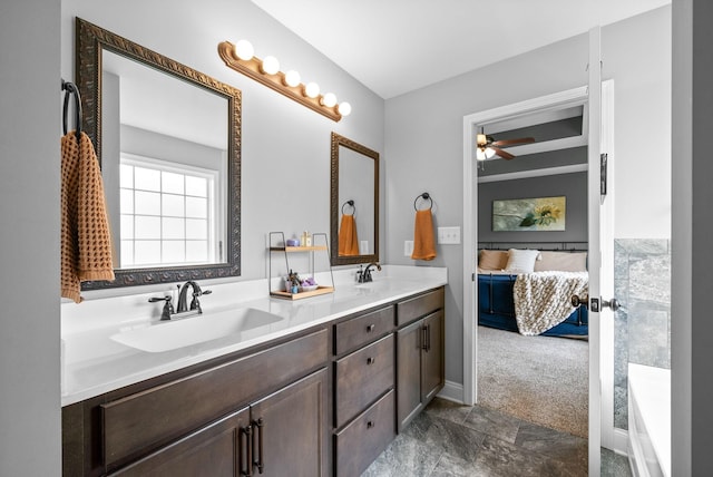 ensuite bathroom with a sink, ceiling fan, ensuite bathroom, and double vanity