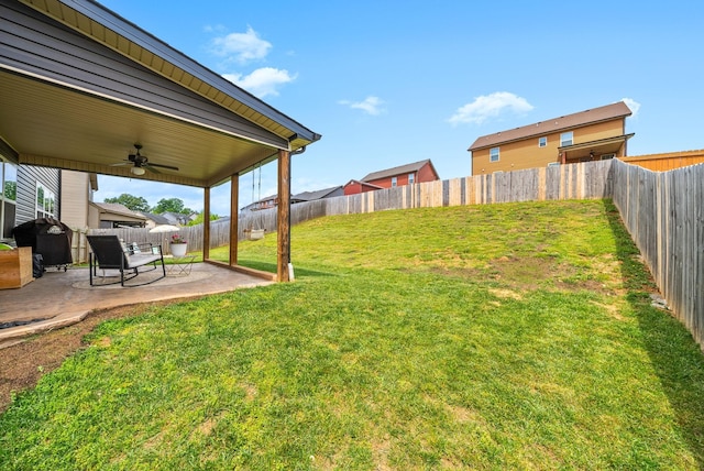 view of yard with a patio, ceiling fan, and a fenced backyard
