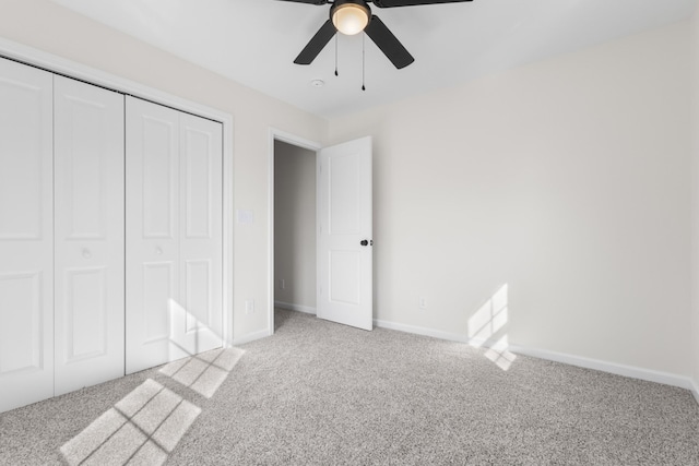 unfurnished bedroom featuring a closet, baseboards, ceiling fan, and light carpet