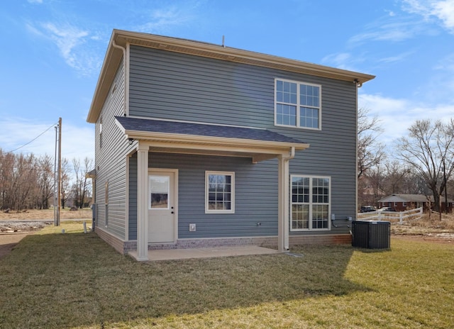 back of house with a lawn, a patio area, and central air condition unit