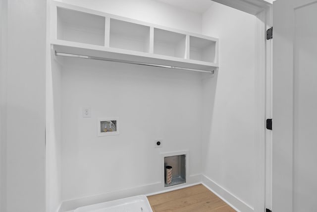 laundry room with laundry area, electric dryer hookup, light wood-type flooring, baseboards, and hookup for a washing machine