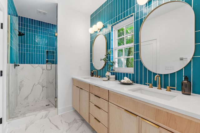 full bath featuring double vanity, a sink, marble finish floor, and a marble finish shower