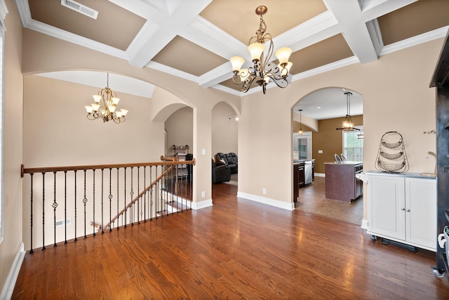 interior space featuring an inviting chandelier, coffered ceiling, and visible vents