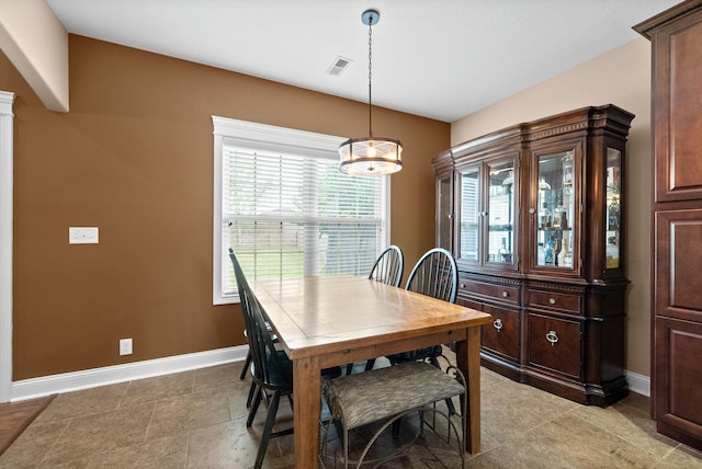 dining area with a notable chandelier, baseboards, and visible vents