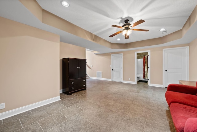living area featuring a ceiling fan, baseboards, and visible vents