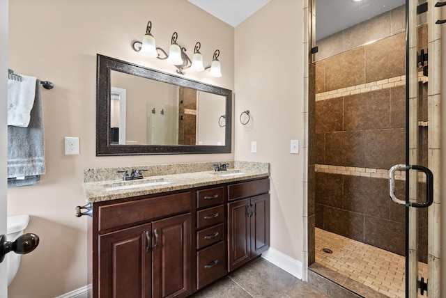 full bath with baseboards, a sink, and a stall shower