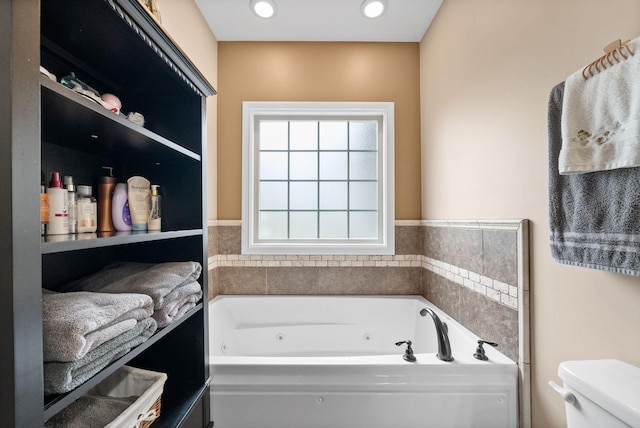 full bath with a tub with jets and toilet