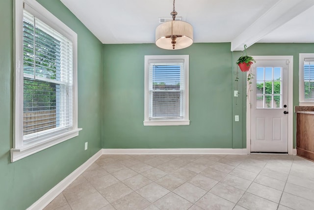 interior space with light tile patterned floors, baseboards, and visible vents