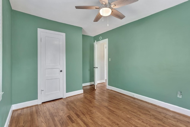 unfurnished bedroom with baseboards, ceiling fan, and wood finished floors