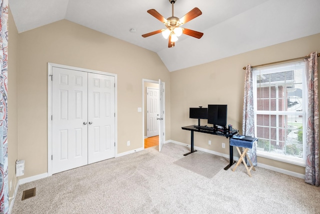 interior space with a ceiling fan, baseboards, vaulted ceiling, and visible vents