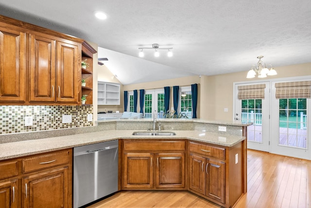 kitchen featuring brown cabinetry, a sink, and dishwasher