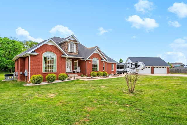 view of front of property featuring brick siding, a garage, driveway, and a front yard