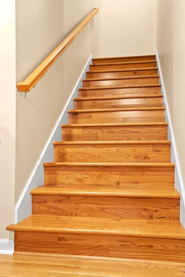 staircase featuring baseboards