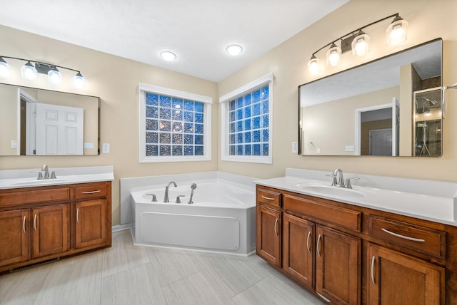 bathroom with a sink, a garden tub, and two vanities