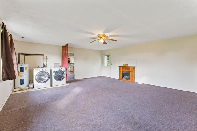 interior space with carpet flooring, a fireplace, a ceiling fan, washer and clothes dryer, and electric water heater