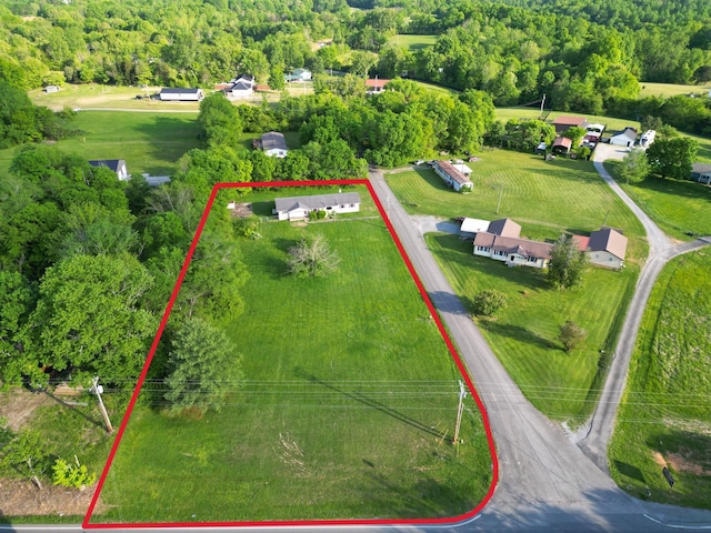 aerial view featuring a wooded view