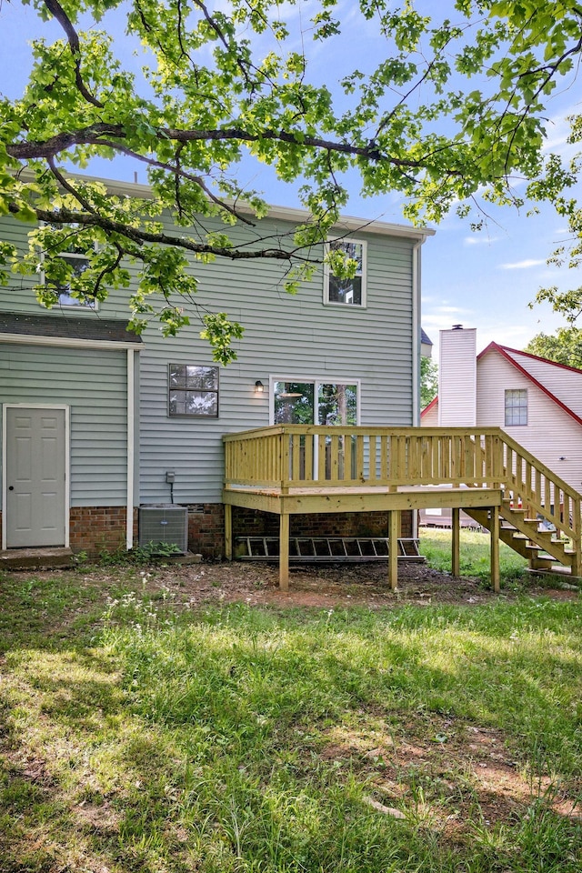 rear view of property featuring central air condition unit, a wooden deck, and stairs