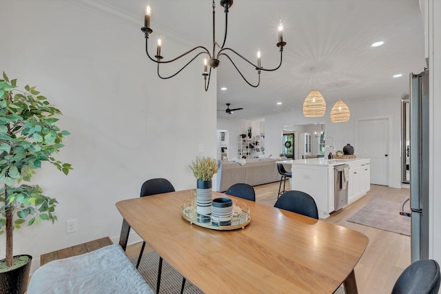 dining area with recessed lighting, ceiling fan with notable chandelier, and light wood-style floors