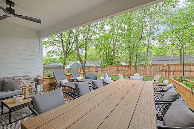 view of patio featuring a fenced backyard, a ceiling fan, outdoor dining space, and an outdoor living space
