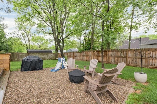 view of yard featuring a fenced backyard and an outdoor fire pit