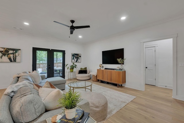 living area with a ceiling fan, french doors, visible vents, crown molding, and light wood-style floors