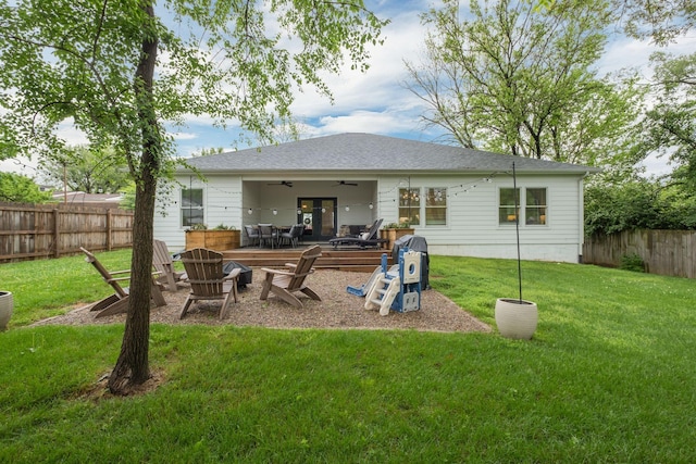 rear view of property featuring a lawn, a patio, ceiling fan, and a fenced backyard