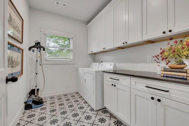 clothes washing area with cabinet space, baseboards, visible vents, and washing machine and dryer