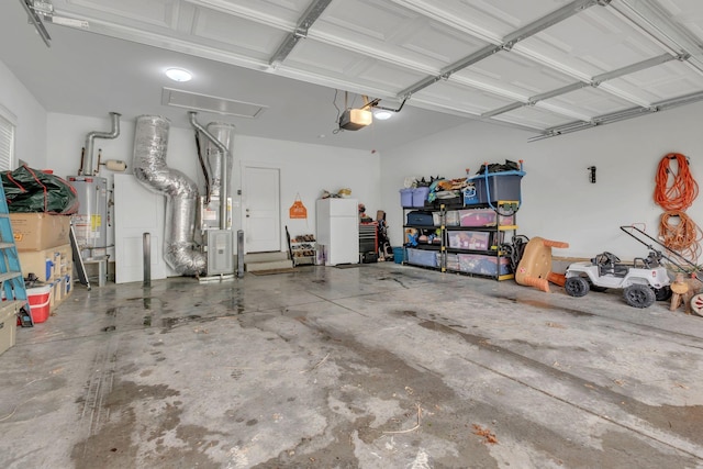 garage featuring water heater, heating unit, and a garage door opener