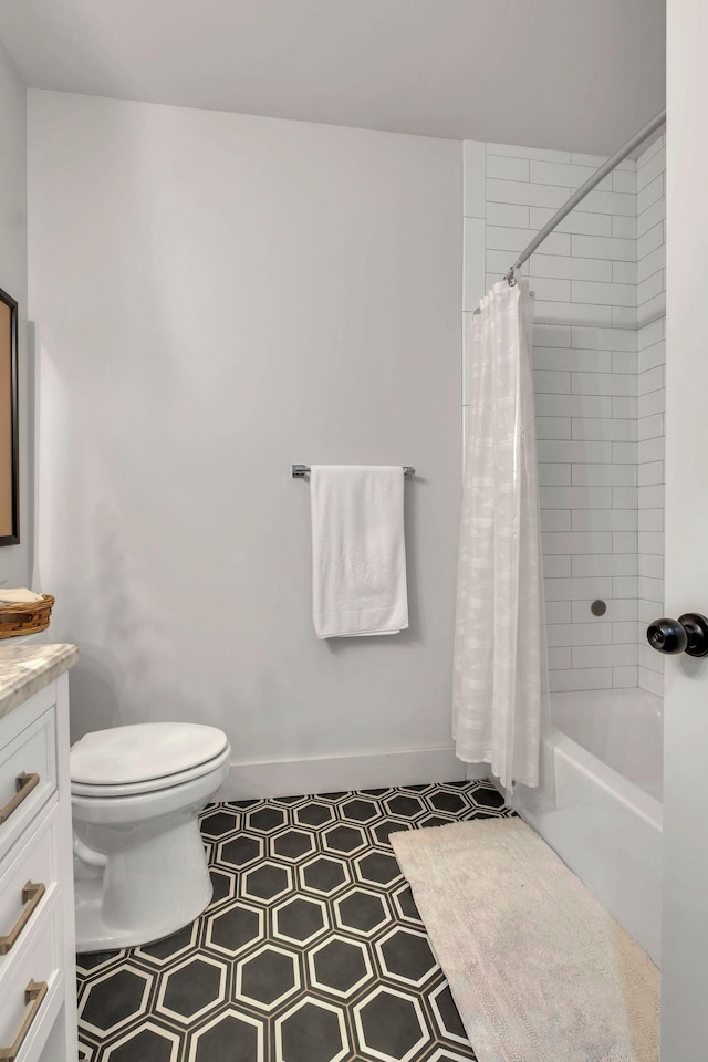 full bath with toilet, shower / bath combo with shower curtain, tile patterned flooring, and vanity
