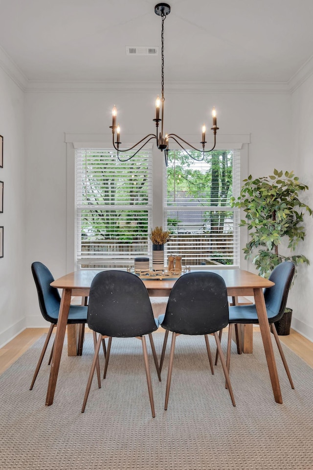 dining area with light wood-style flooring, a chandelier, and a healthy amount of sunlight