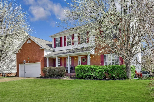 traditional home featuring a porch, brick siding, a garage, and a front lawn