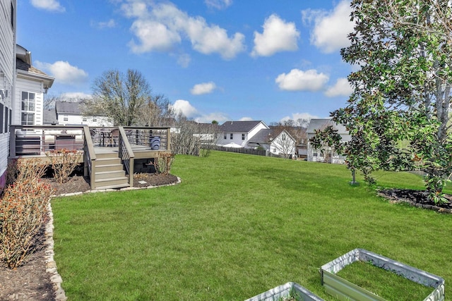 view of yard featuring a wooden deck and a residential view