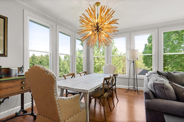 sunroom featuring french doors, ornamental molding, baseboards, and wood finished floors