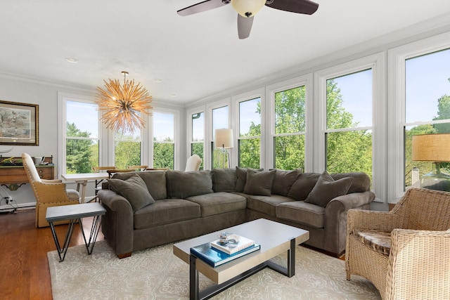 sunroom / solarium with crown molding and wood finished floors