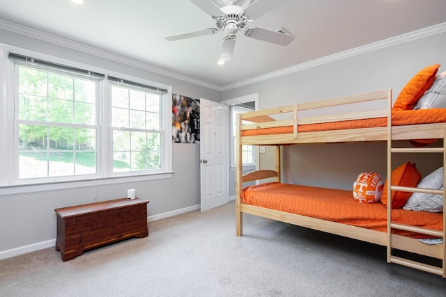 bedroom with baseboards, carpet flooring, crown molding, and ceiling fan