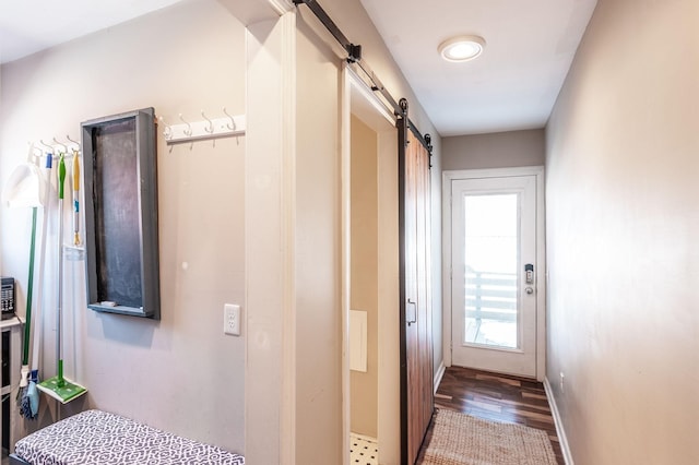108 High St, Portland, TN 37148 - hallway featuring a barn door, wood finished floors, and baseboards