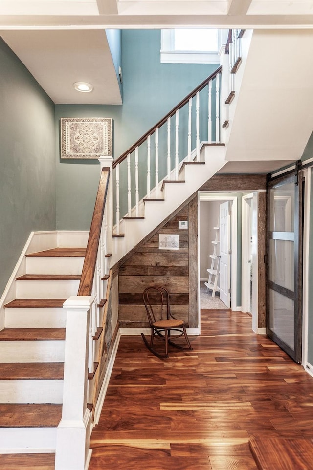 108 High St, Portland, TN 37148 - staircase featuring wood finished floors, a barn door, and baseboards
