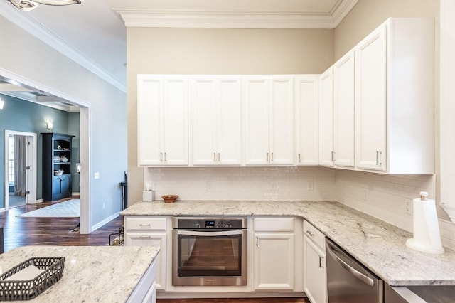 108 High St, Portland, TN 37148 - kitchen with appliances with stainless steel finishes, dark wood-style flooring, backsplash, white cabinets, and light stone counters