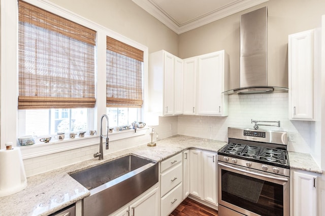 108 High St, Portland, TN 37148 - kitchen with stainless steel appliances, wall chimney exhaust hood, a sink, backsplash, and white cabinetry